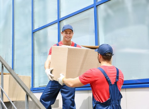 Professional movers packing items for a move